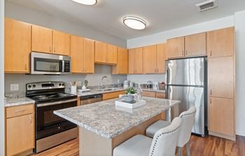 Fitted kitchen with island dining